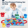A toddler is playing with a fishing set featuring 22 pieces including fish and stacking cups on a blue mat.