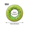 A green inflatable pool float ring shaped like a slice of fruit with black seeds.