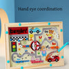 A wooden maze board for hand eye coordination featuring colored magnetic pieces and a road theme.