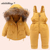 A mustard yellow baby winter down jacket and pants set with a faux fur hood.