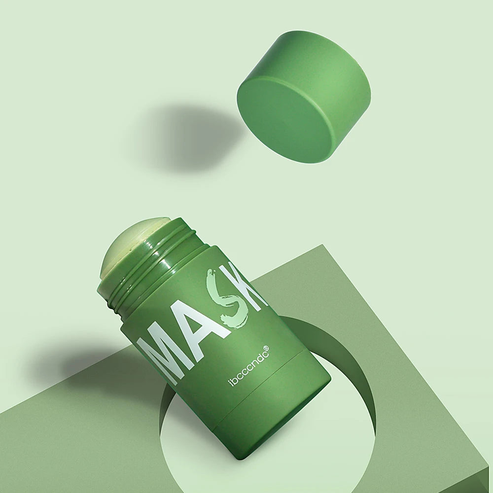 A green cleansing stick mask product shown in a jar and loose form on a light green background.