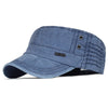 A dark blue washed cotton flat cap with a curved brim and visible stitching details.