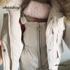 A close-up of a beige baby winter down jacket and pants set with a faux fur hood.