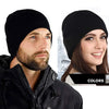 A man and a woman wearing black knitted winter beanie hats.