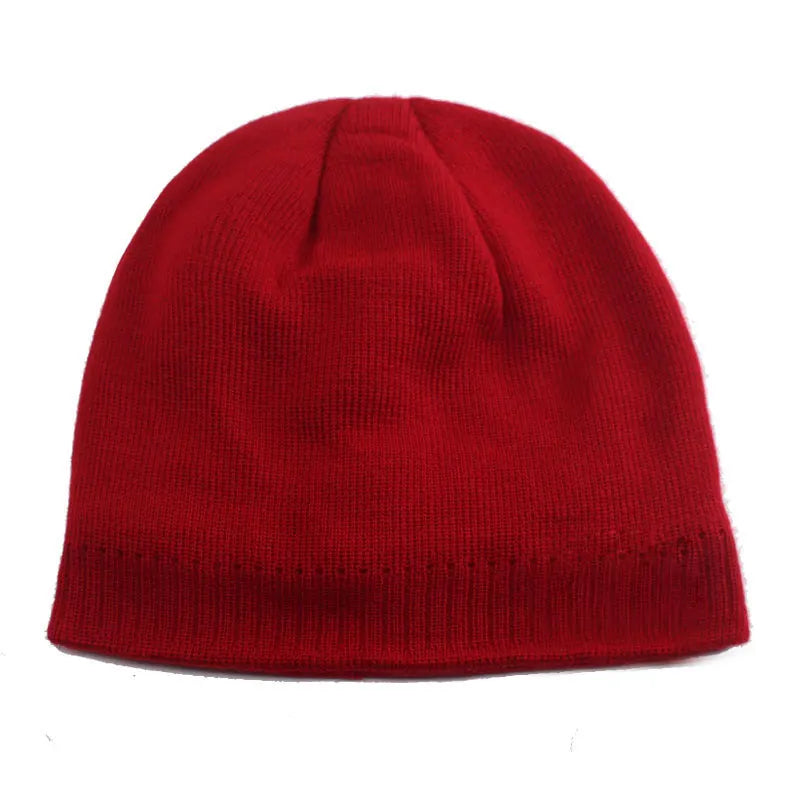 A close-up view of a solid red knitted winter beanie hat.