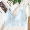 Light blue seamless U-back bralette top displayed on a white background next to a magazine.