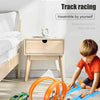 A child is assembling a blue and orange track racing set for double competition track racing.