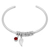 Silver bracelet featuring a leaf charm and a red birthstone bead.