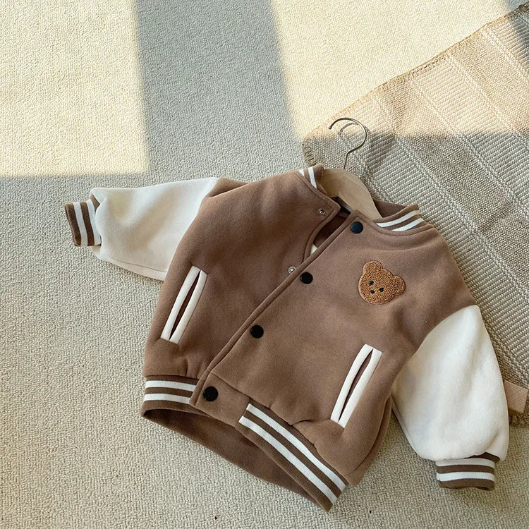 A brown fleece-lined corduroy jacket for a toddler, featuring white stripes on the cuffs and hem.
