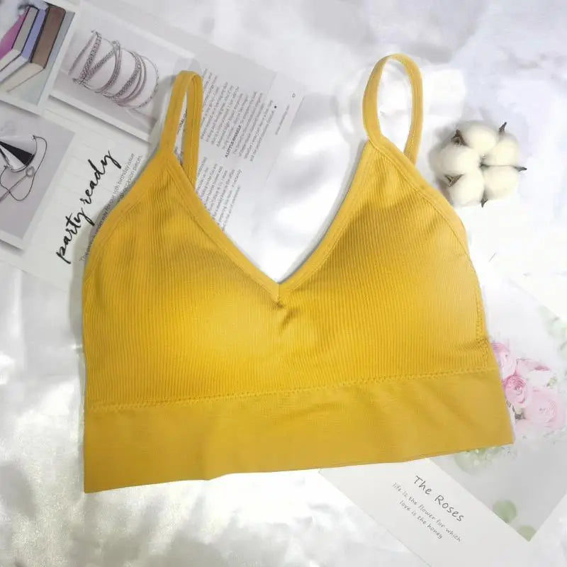 A yellow seamless U-back bralette with removable pads displayed on a white background.
