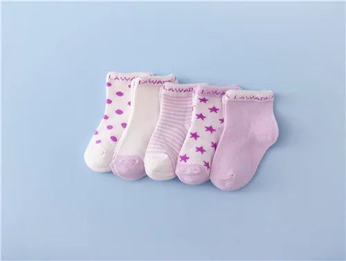 A set of five baby socks in various shades of pink and white with small purple stars.