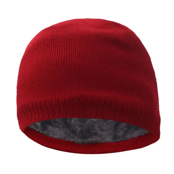 A deep red knitted winter beanie hat with a gray faux fur lining.