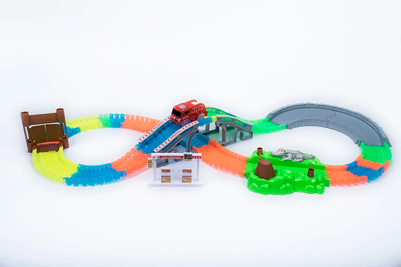 A glowing magnetic race track set featuring ramps, bridges, and a red vehicle on an orange and green track.