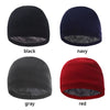 Four knitted winter beanie hats in black, navy, gray, and red shown from the top.