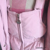 A pink baby winter down jacket and pants set with a faux fur hood displayed on a mannequin.