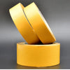 Two pieces of yellow heavy-duty fiberglass tape stacked diagonally on a cylindrical roll.