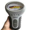 A hand holds a white digital pH and chlorine tester device with a clear scale display.