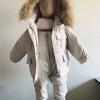 A beige baby winter down jacket and pants set with a faux fur hood displayed on a mannequin.