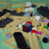 A close-up view of various wooden and plastic puzzles, including a mini 3x3 speed cube.