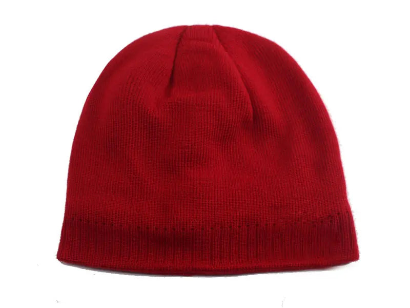 A solid red knitted winter beanie hat with a ribbed cuff.