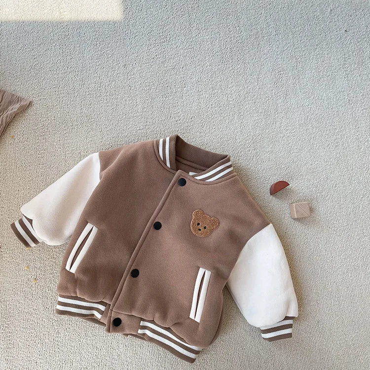 A brown corduroy jacket with white stripes and a cream fleece lining is displayed on a light background.