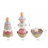 A set of rainbow boat-shaped stacking cups for bath and beach fun in pastel colors.