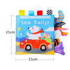 A soft cloth book titled Sea Tails featuring a white polar bear driving a red car and various animal tails.