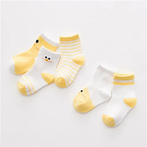 A set of yellow and white striped cotton baby socks displayed on a white background.