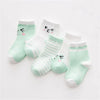 A set of light mint green and white striped cotton baby socks with cute face designs.