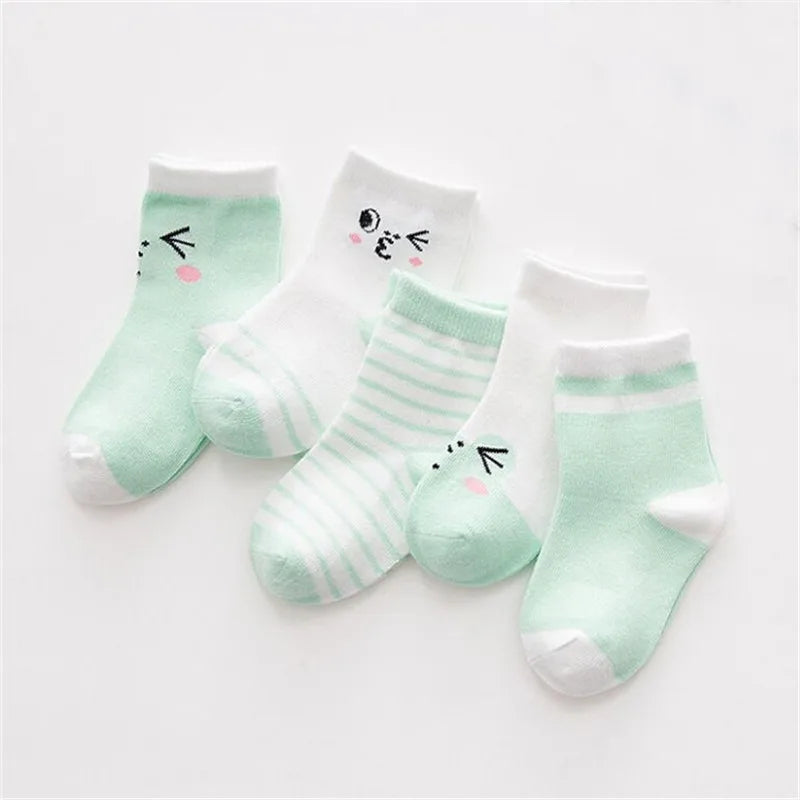 A set of light mint green and white striped cotton baby socks with cute face designs.