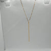 A delicate gold-toned stick pendant bar necklace with a geometric design displayed against a white background.