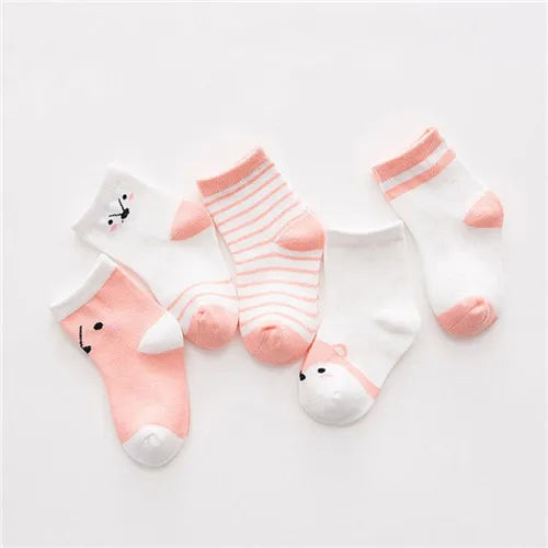 A set of five pink and white striped cotton baby socks laid out on a white background.