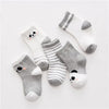 A set of five striped cotton baby socks featuring cute animal designs in gray and white.