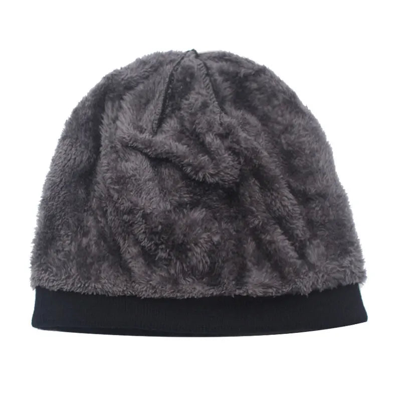 A dark gray faux fur knitted winter beanie hat with a black brim.