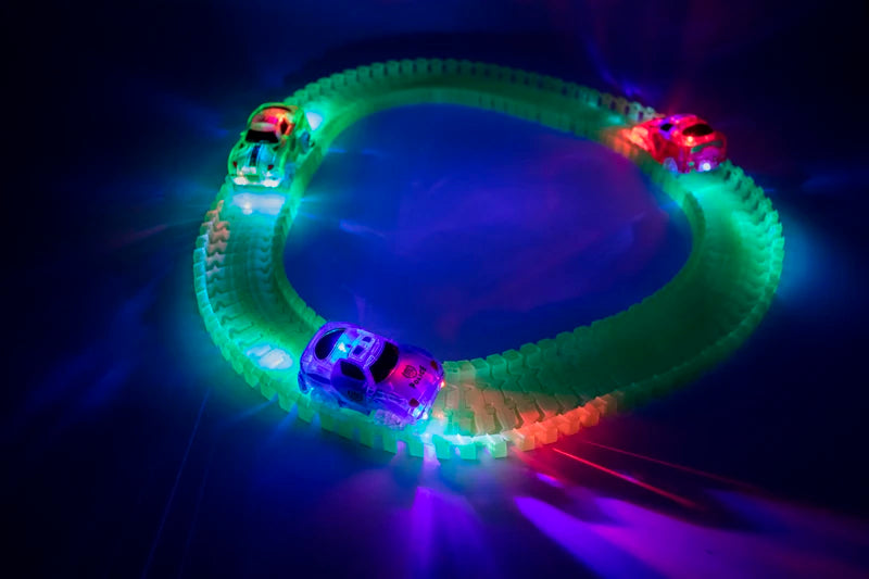 Glowing magnetic race track set featuring ramps and bridges with multiple illuminated cars.