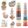 A set of rainbow boat-shaped stacking cups for bath and beach fun in various pastel colors.