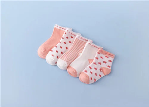 A set of pink and white striped cotton baby socks laid out on a light blue background.