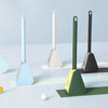 A collection of light blue and green golf-style silicone toilet brushes with self-opening holders displayed on a white surfac