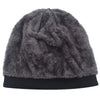 A dark gray faux fur knitted winter beanie hat with a black brim.