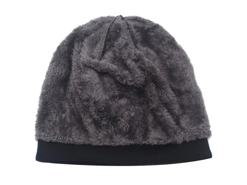 A dark gray faux fur knitted winter beanie hat with a black brim.