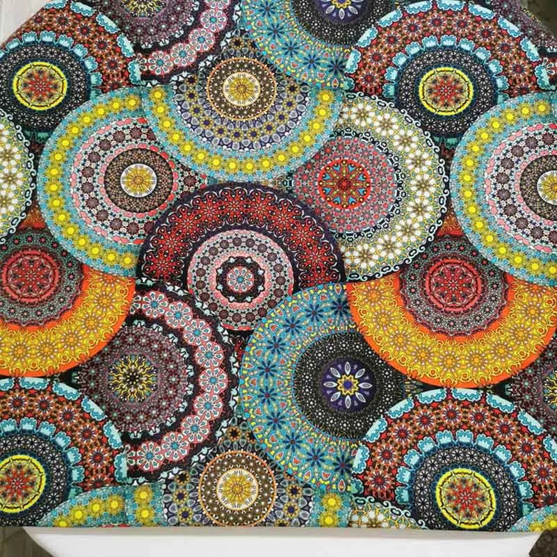 Close-up of colorful bohemian mandala cotton fabric with intricate patterns for sewing and DIY crafts