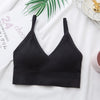 Black seamless U-back bralette with removable pads displayed on a white surface.
