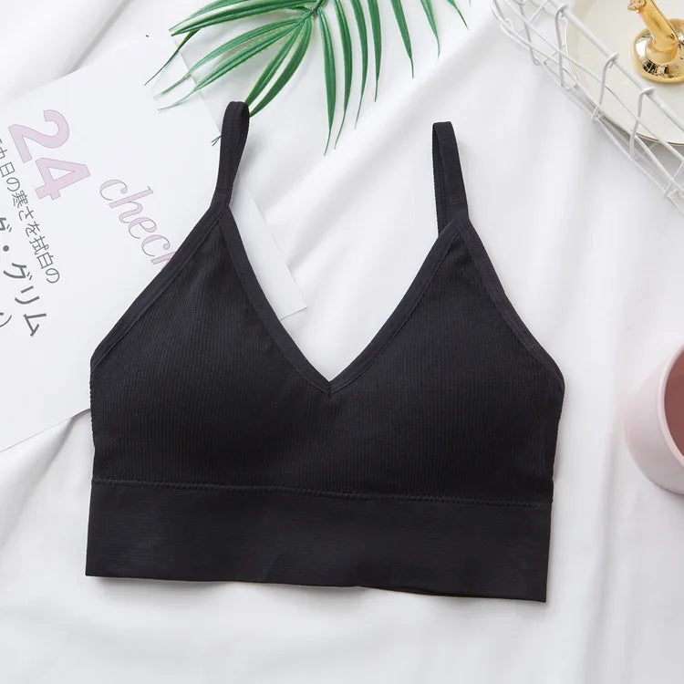 Black seamless U-back bralette with removable pads displayed on a white surface.