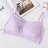 A light purple seamless U-back bralette with removable pads lying on a white surface.