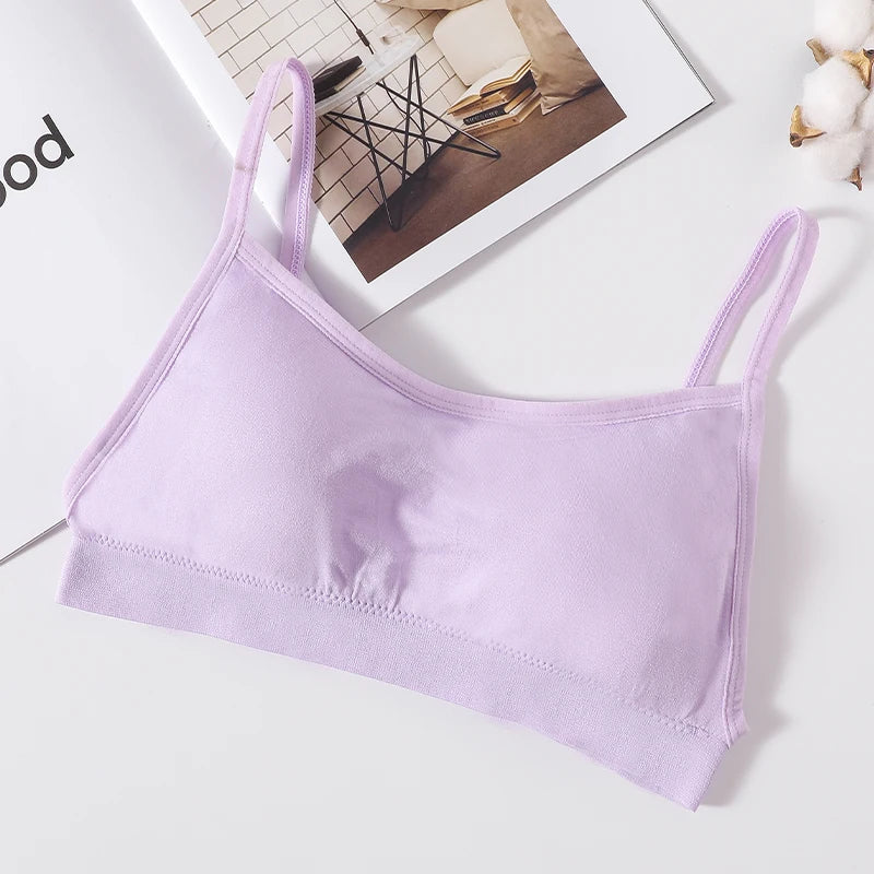 A light purple seamless U-back bralette with removable pads lying on a white surface.