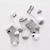 A set of five striped cotton baby socks featuring cute panda designs