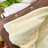 A close-up of a brown corduroy jacket with a cream fleece lining and white trim.