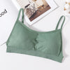 A sage green seamless U-back bralette with removable pads displayed on a white surface.