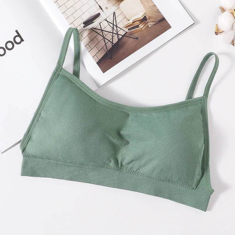A sage green seamless U-back bralette with removable pads displayed on a white surface.