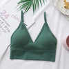 A dark green seamless U-back bralette with a V-neck and removable pads is displayed on a white background.